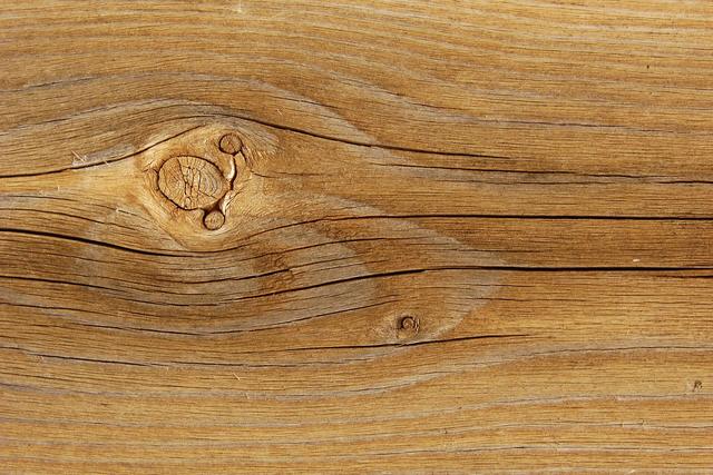 Close up of weathered timber deck board grain with a knot